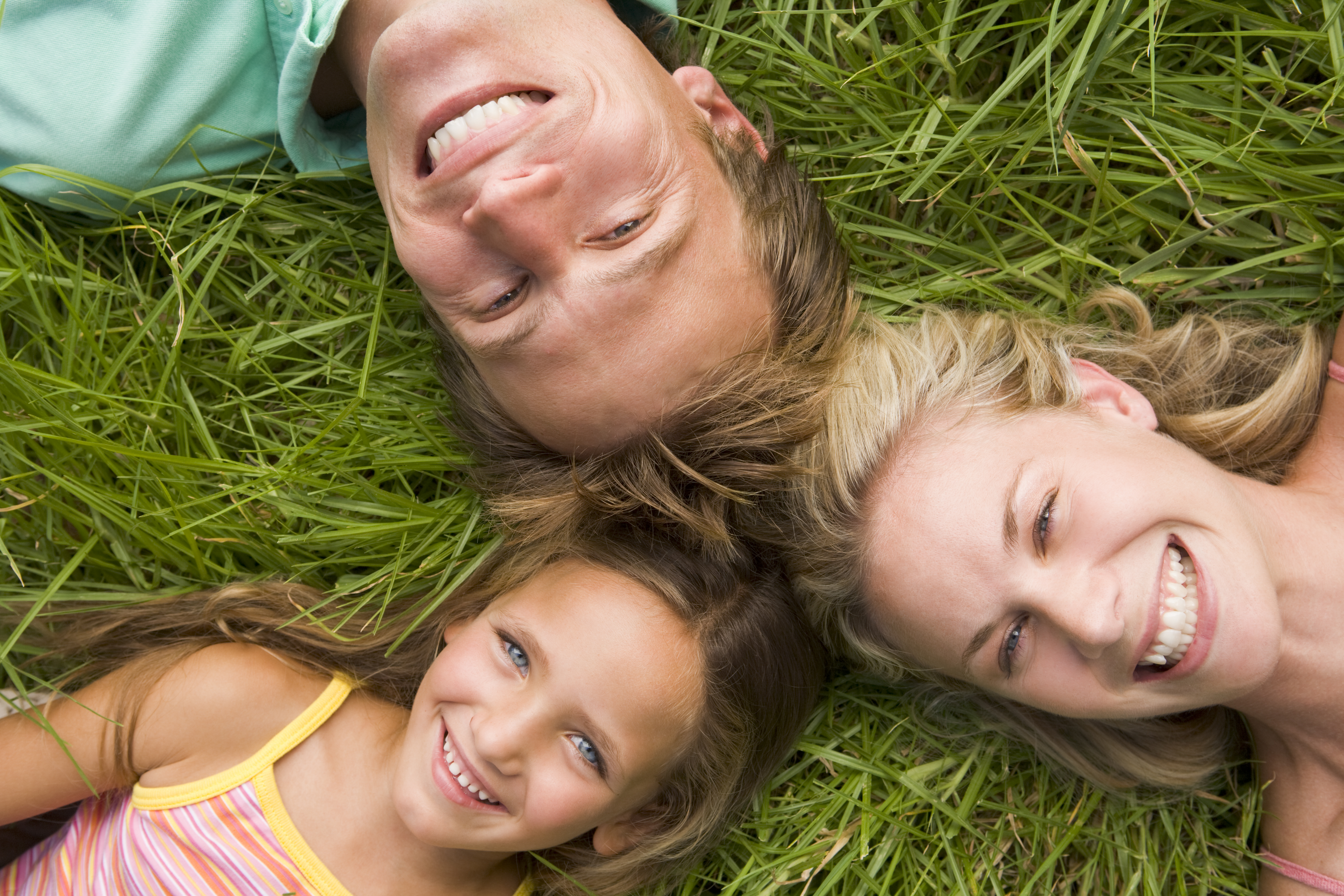 Happy family — father, mother and young daughter smiling together — representing family block dental appointments at Merry Dental Hub, Wylie TX 75098